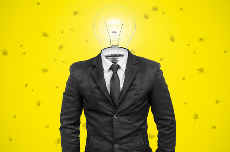 Suit with idea bulb head on background.の写真素材