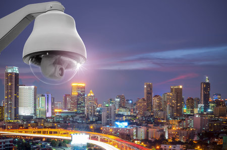 CCTV monitoring, security cameras. Backdrop with views of the city during twilight.