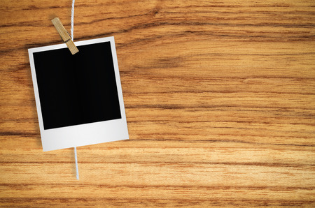 Blank photo frame with clothespin hanging on wall background, with clipping path.の写真素材