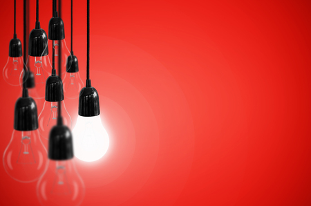 Idea concept with light bulb on the background red color.の写真素材