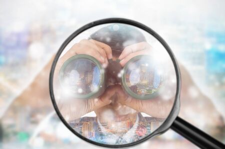 Examining business with magnifying glass, concept examining.の写真素材