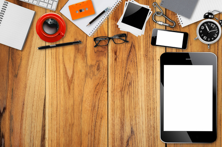 Top view desks with smartphone, keyboard, pencil, coffee mug, glasses, photo paper, Cassette Tapes and other business supplies.の写真素材