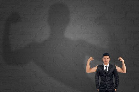 Businessman with muscled arms, concept strong.の写真素材