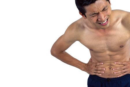 Stomach ache, man placing hand on the spot isolated on white with clipping path.の写真素材