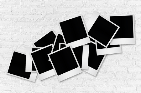 Blank photo frame on white brick wall background with clipping path.の写真素材