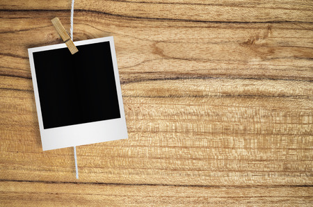 Blank photo frame with clothespin hanging on wall background, with clipping path.の写真素材