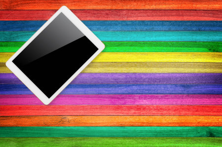 Digital tablet computer with isolated screen with clipping path on wooden background.
