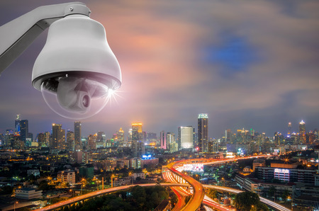 CCTV monitoring, security cameras. Backdrop with views of the city during twilight.の写真素材