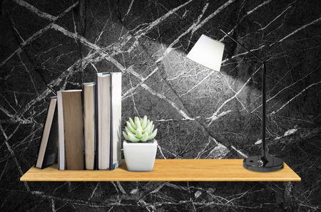 Top wooden shelves with cactus,book,table lamp and marble wall background - For product display.の写真素材