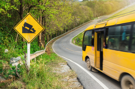 Traffic alerts downhill slope. Reduce speed and use a lower gear. Drive with caution.の写真素材