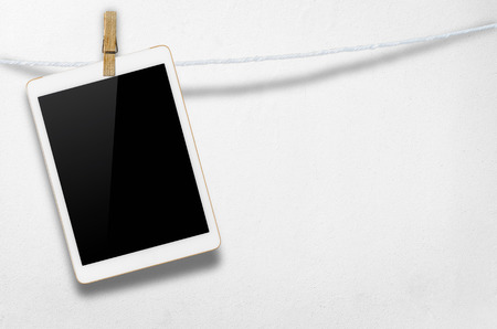 Hanging blank digital tablet computer with isolated screen with clipping path.の写真素材