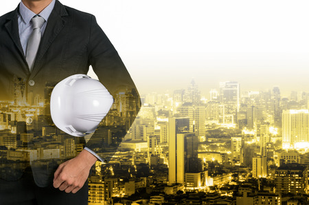 Double exposure of engineer with blurred industrial background.の写真素材