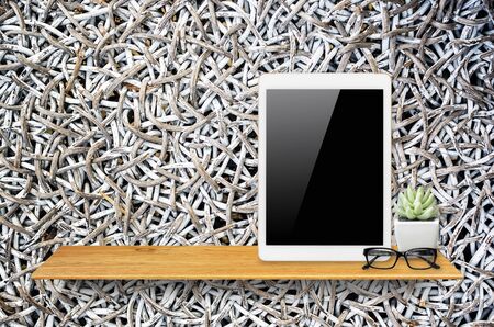 Digital tablet computer with isolated screen with clipping path on bookshelf in the wall.の写真素材