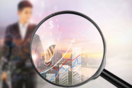 Examining business with magnifying glass, concept examining.の写真素材