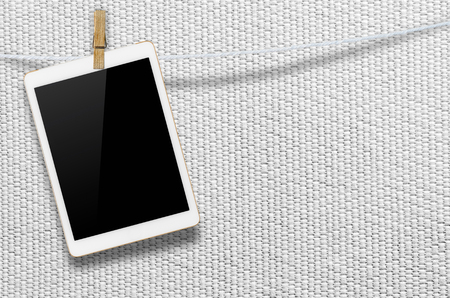 Hanging blank digital tablet computer with isolated screen with clipping path.の写真素材
