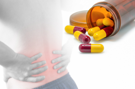 Antibiotic capsules red and yellow blur of back pain.の写真素材