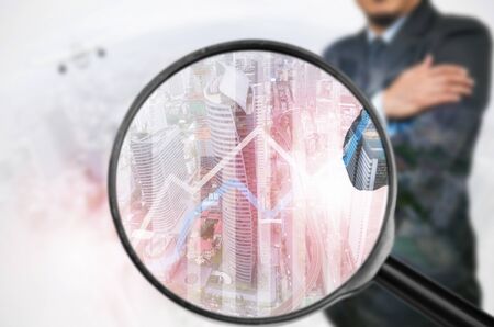 Examining business with magnifying glass, concept examining.の写真素材