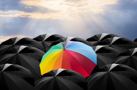 Umbrella in mass of black umbrellas.の写真素材