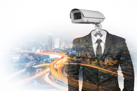 Double exposure Suit with security CCTV head on blurred cityscape background.の写真素材