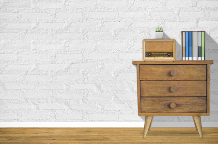 Interior design with plant, books, old Radio on old wooden dresser in front of white wall.の写真素材