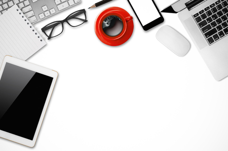Office desk table with laptop, mouse, digital tablet, notepad, pencil and coffee cup, Top view with copy space.の写真素材