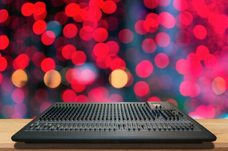 Mixer music, mixer board, mixer on desk with blurred light background.の写真素材