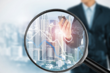 Examining business with magnifying glass, concept examining.の写真素材