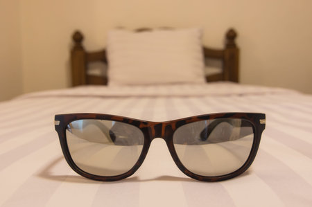 Glasses on the bed The concept of relaxation.