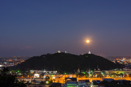 Full moon with pagoda on the hill in the twilight time, Phetburi Thailand.の写真素材