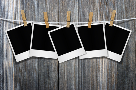 Blank photo frame with clothespin hanging on wall background, with clipping path.の写真素材