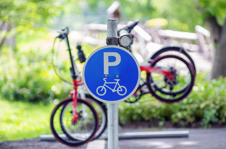 Bicycle parking sign in public park with bicycle.の写真素材