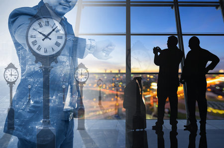Double exposure of a businessman and airport, look his watch.の写真素材