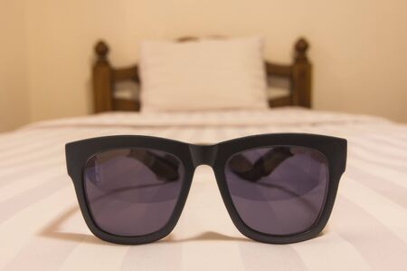 Glasses on the bed The concept of relaxation.の写真素材