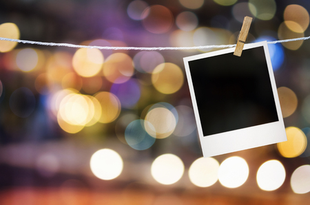 Photo frame paper hanging on bright spot blurred with clipping path in blank screen.の写真素材
