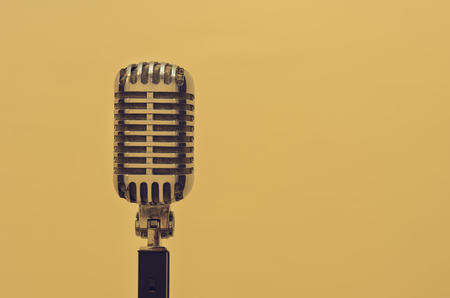 Vintage microphone on wall blurred background.の写真素材