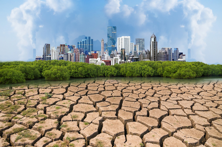 Global warming, Dry cracked earth with Pollution modern city.の写真素材