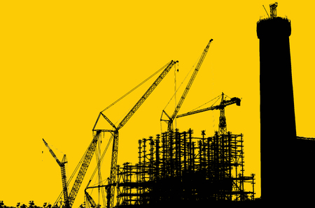 Silhouettes of large structures and cranes.の写真素材