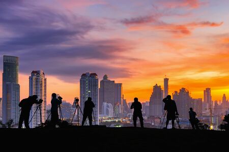 Silhouettes of many photographers. Beautiful sky and sunrise.の写真素材