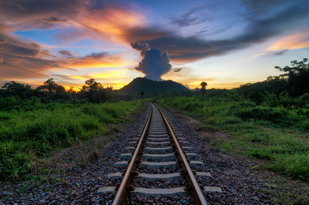 Railroad tracks in the during sunrise, dramatic sunset over railroad.の写真素材