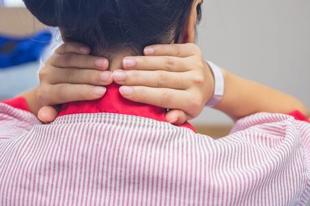 Female patient with back pain in hospital rooms.の写真素材