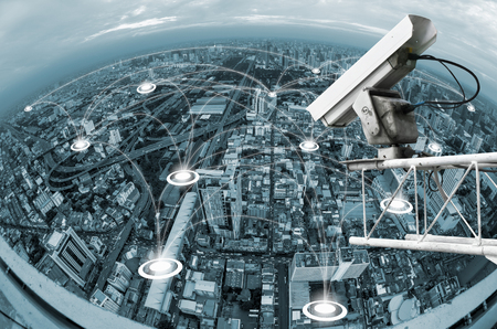 Monitoring security camera on backdrop of the blue blur building with network.の写真素材