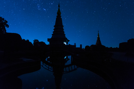 Silhouette landmark pagoda in doi Inthanon national park with star at Chiang mai, Thailand, Long Exposure with noise.の写真素材