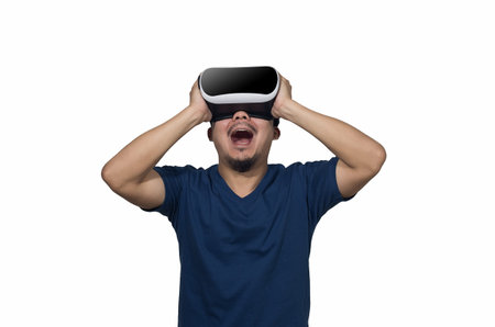 Young man with a virtual reality goggles isolated on white.