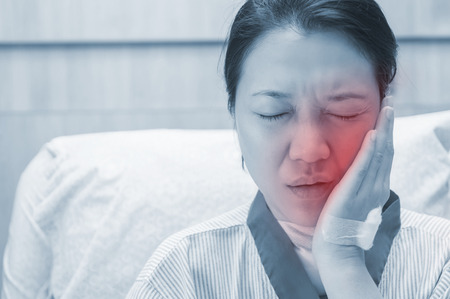 Female patients with toothache in the hospital room.の写真素材