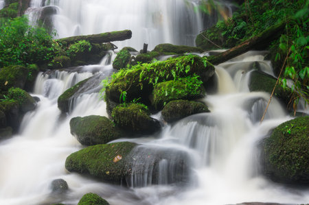 Man Daeng waterfall, Waterfall with autumn color change Beautiful nature.