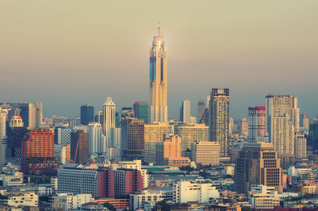 Aerial view of Bangkok modern office buildings, condominium in city downtown with sunset sky,...