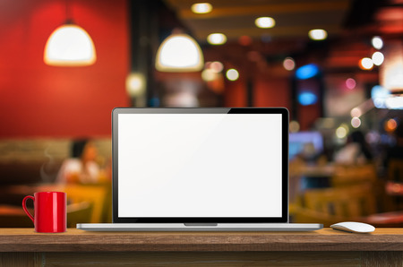 Laptop computer blank screen on wooden table and blurred Coffee shop interior background with bokeh image, for product display montage,can be used for montage or display your products.
の写真素材