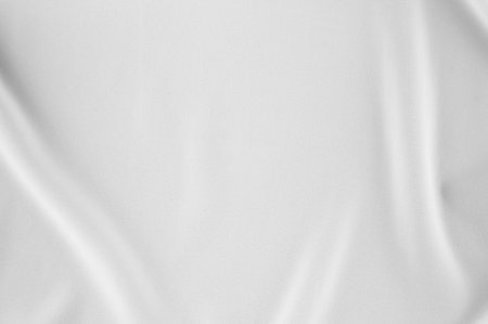 Smooth elegant white silk or satin luxury cloth can use as wedding background. Luxurious Christmas background or New Year background design. white fabric texture. Cloth Textile Surface. top view.の写真素材