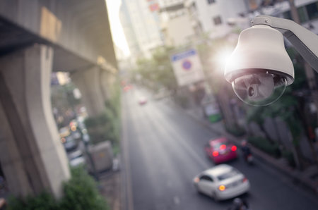 CCTV cameras, security cameras. With the backdrop tail lights blurred on the road from a high angle.