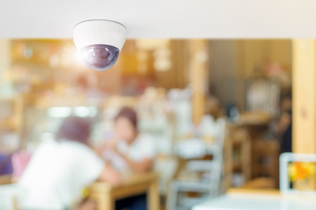 CCTV system security inside of restaurant, Surveillance camera installed on ceiling to monitor for protection customer in restaurant, Concept of surveillance and monitoring.の写真素材